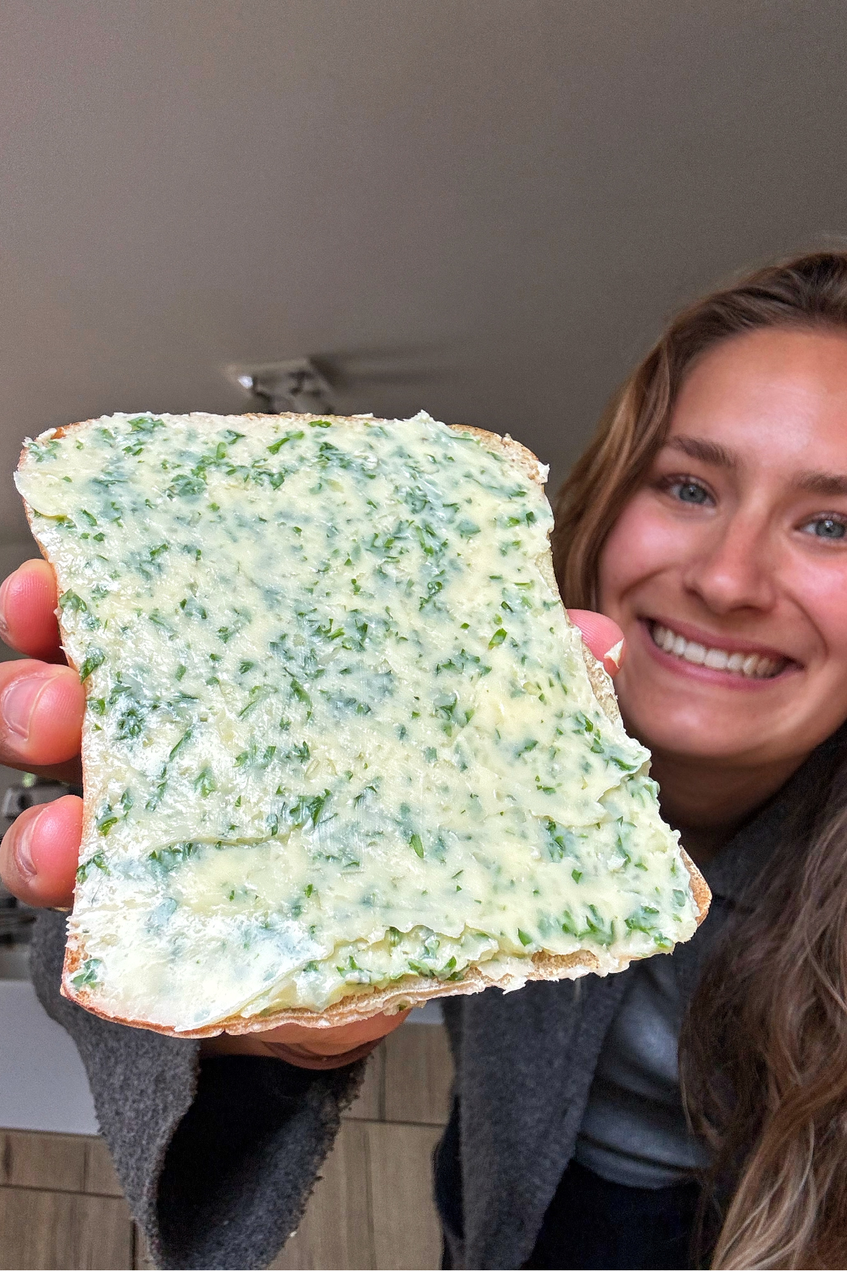 Garlic butter spread on ciabatta with Emily Roz in the background.