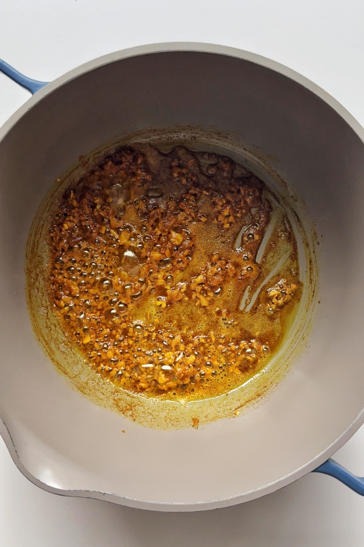 Frying off spices in a pan.