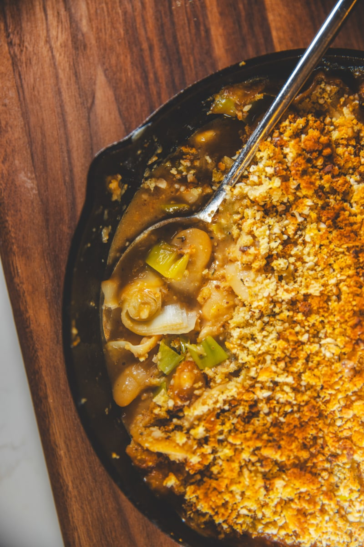 leek butter bean gratin in a black dish.