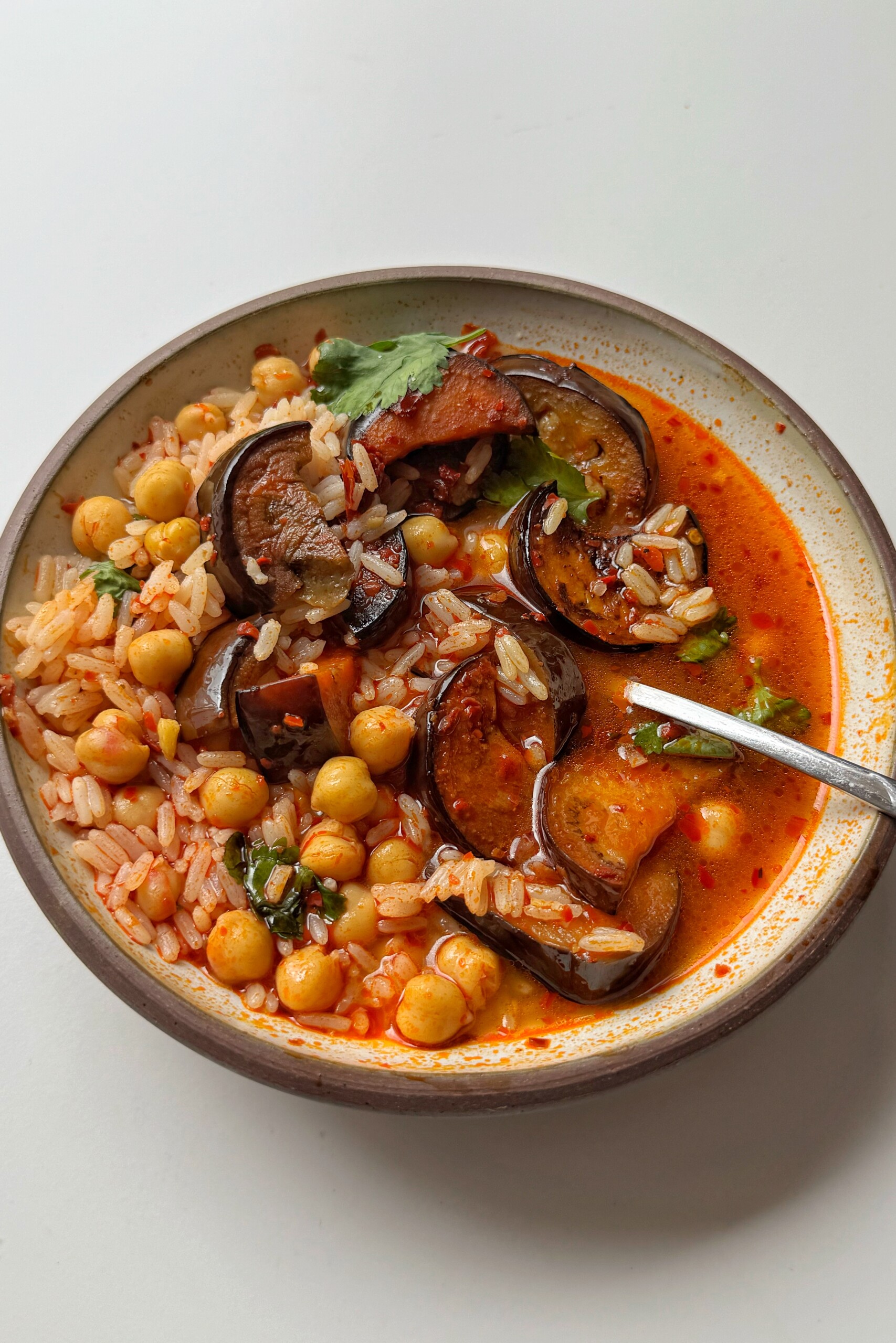Bowl of harissa rice with aubergine.