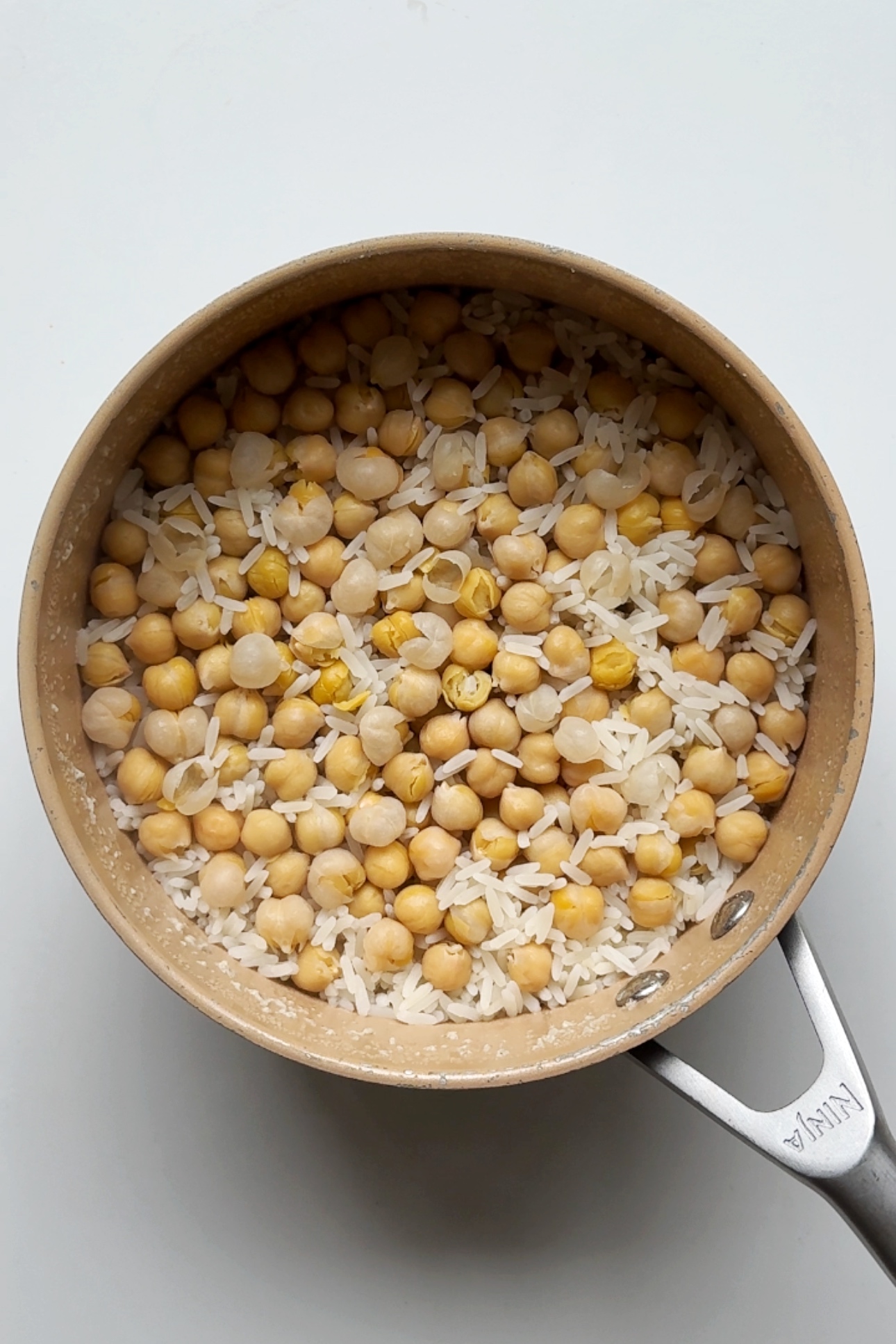 Rice and chickpeas in saucepan.