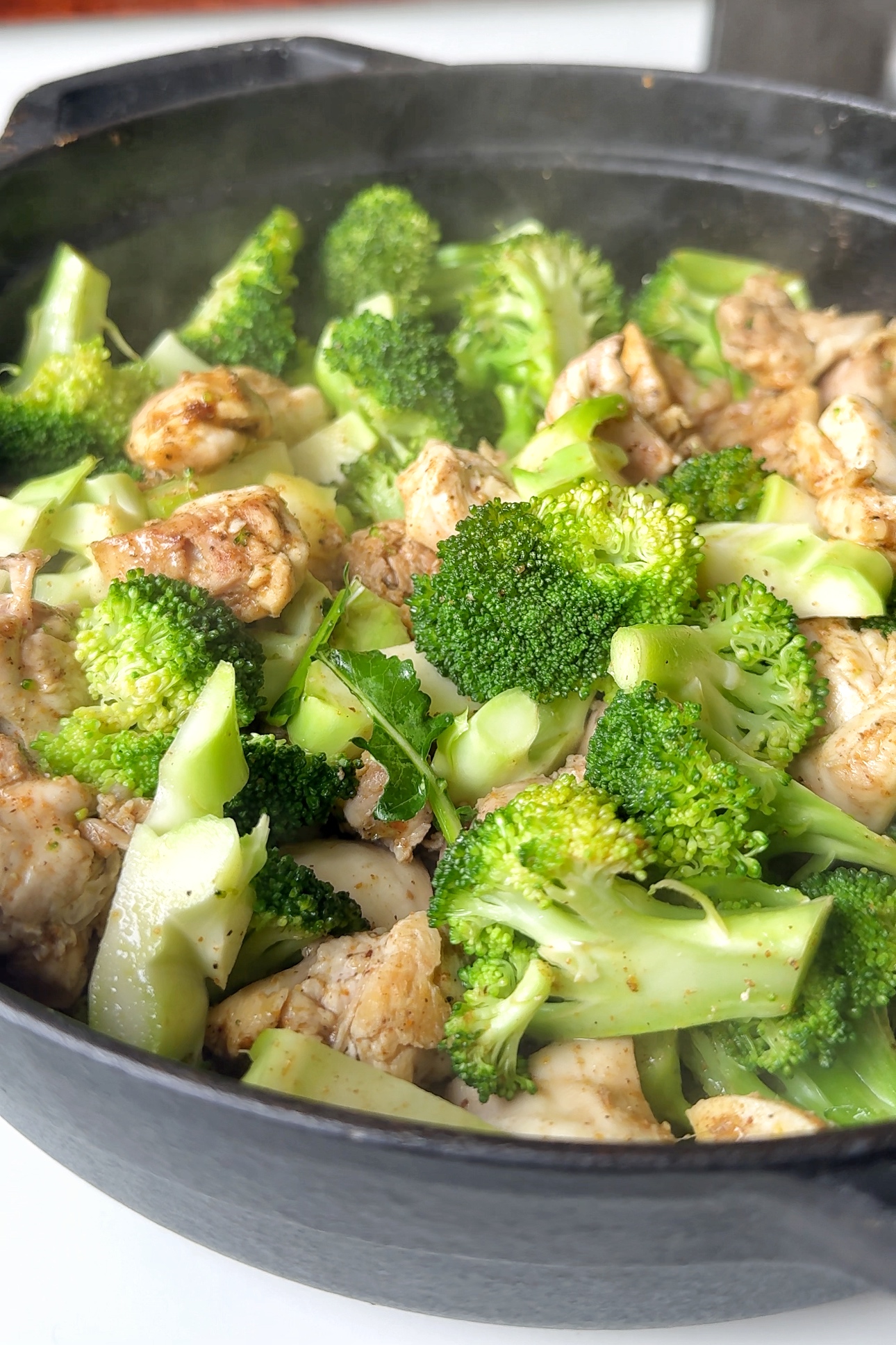 Frying chicken and broccoli.