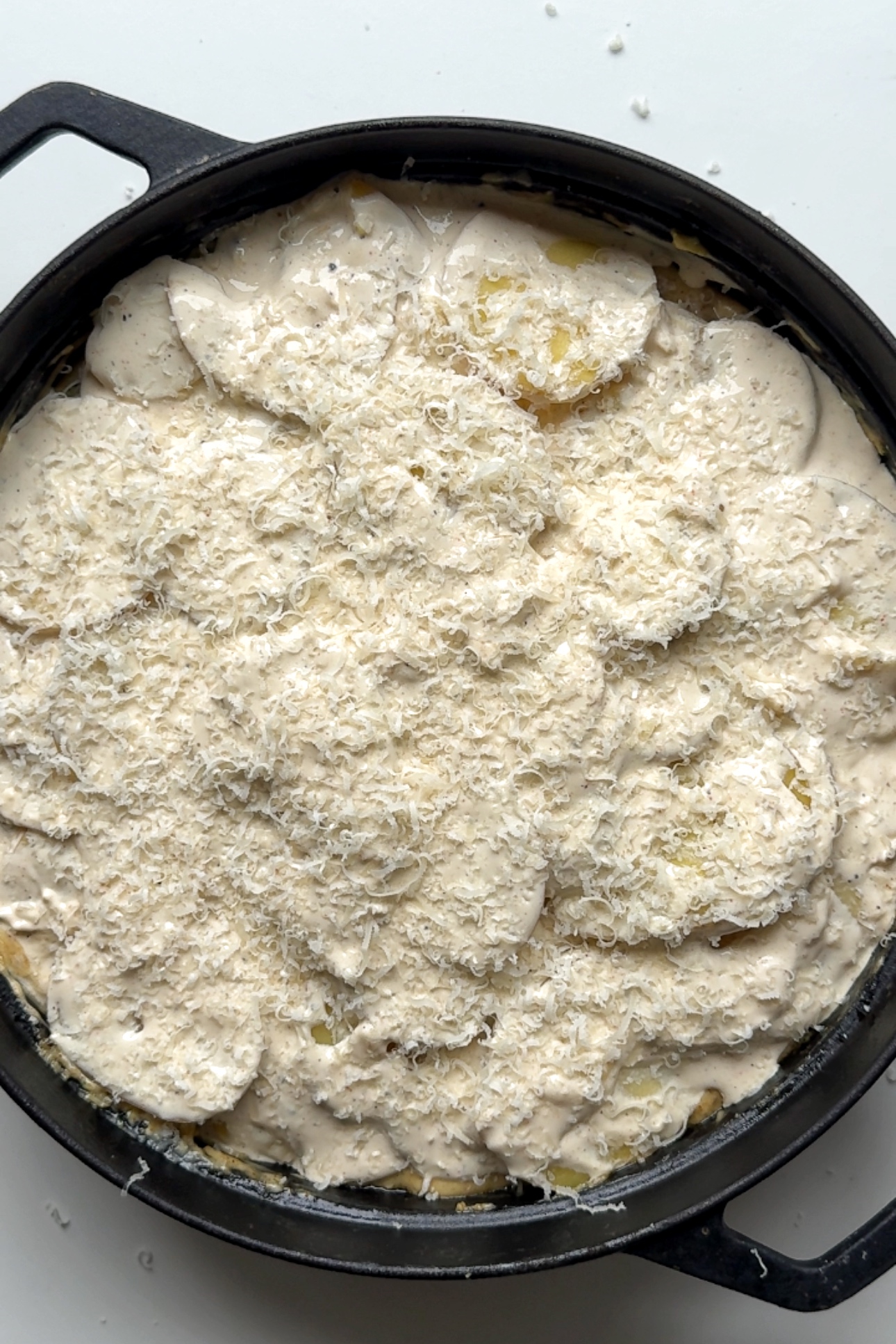 Grating parmesan on top of the dish