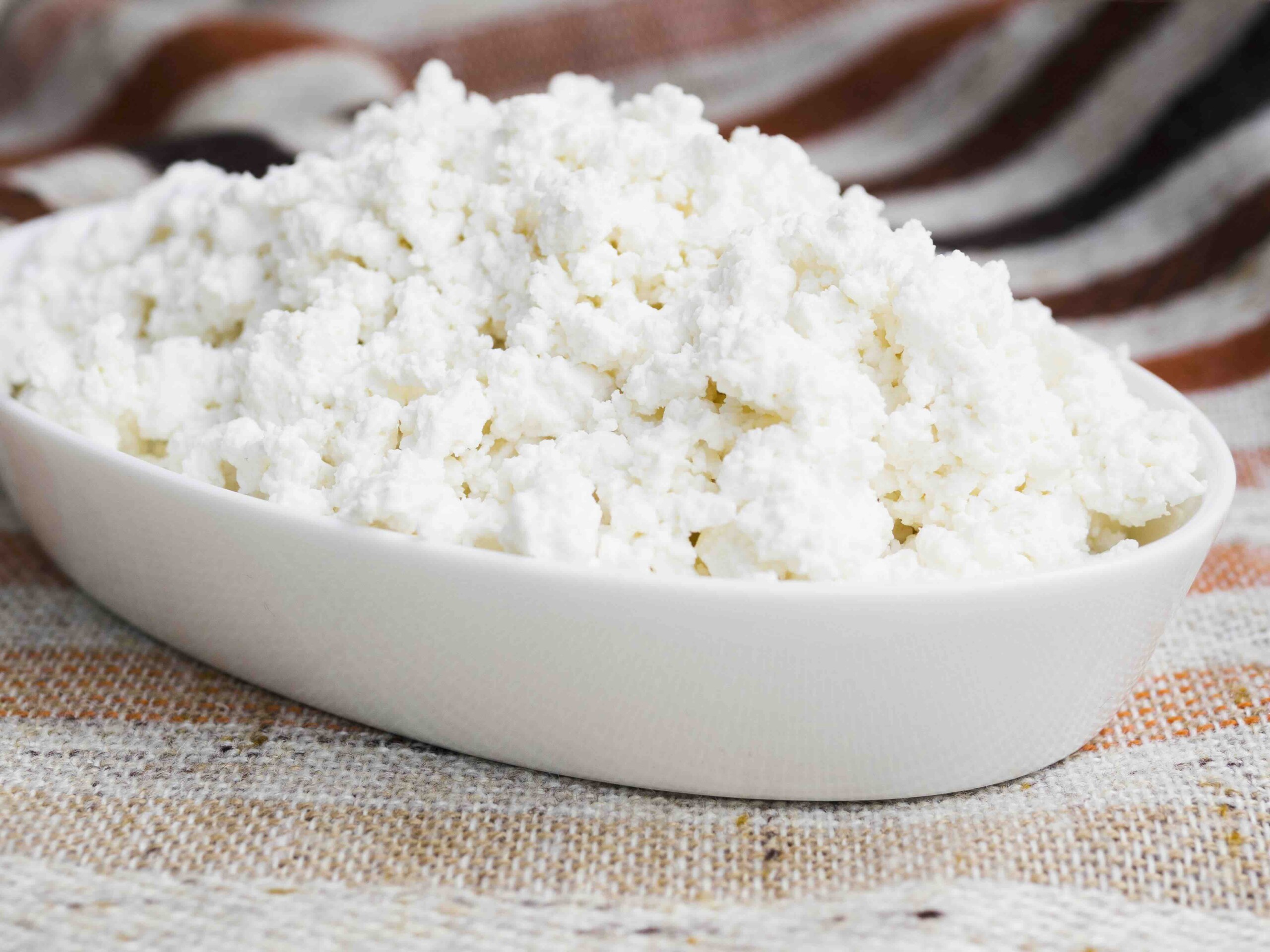 A white bowl full of cottage cheese as a greek yogurt replacement