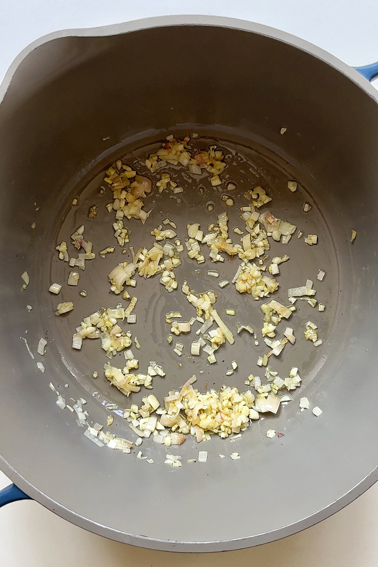 Frying garlic and shallots in a pan.