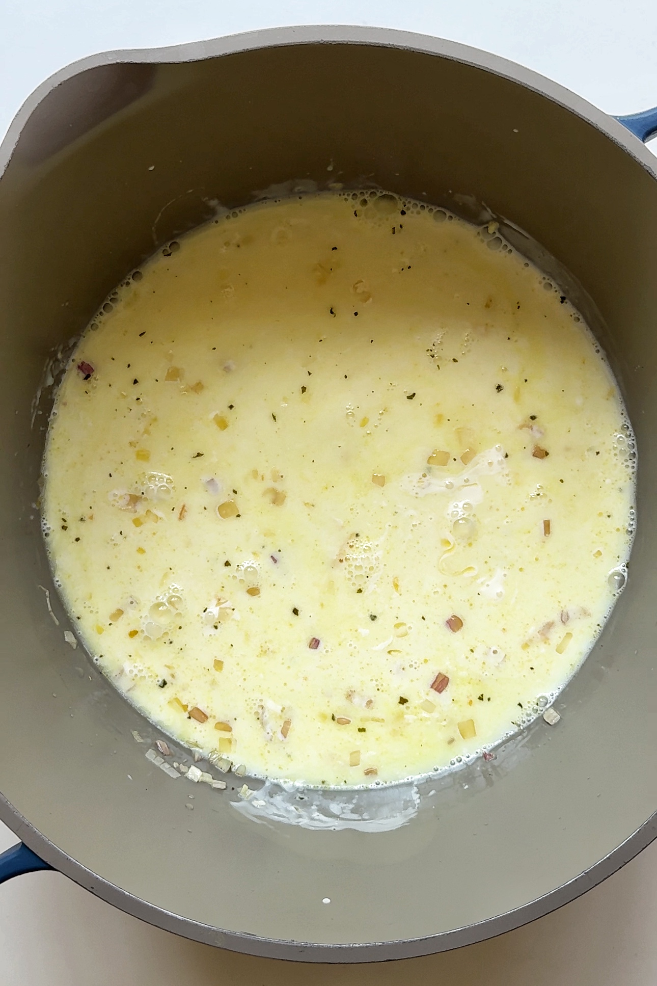 Cooking cream in a pot.