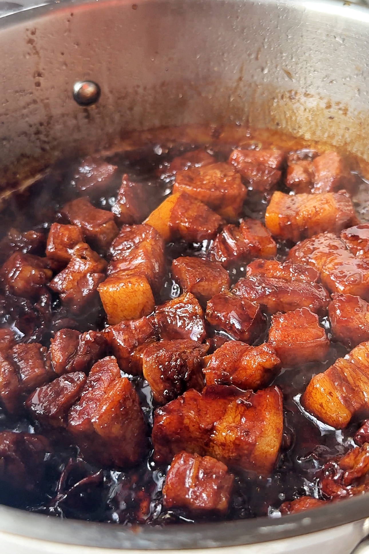 Caramelised sticky pork belly in pan.