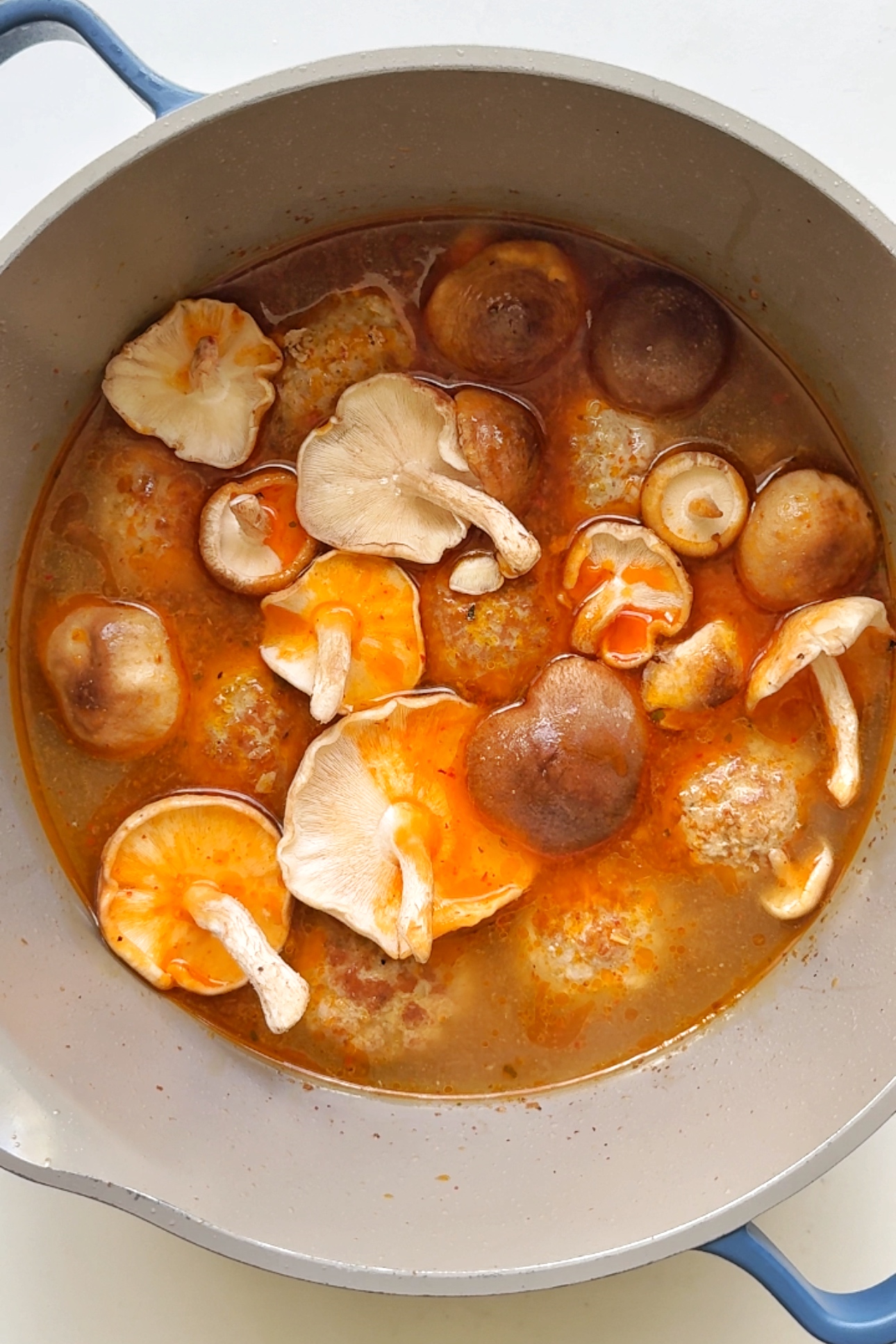 one pot with noodle soup inside.
