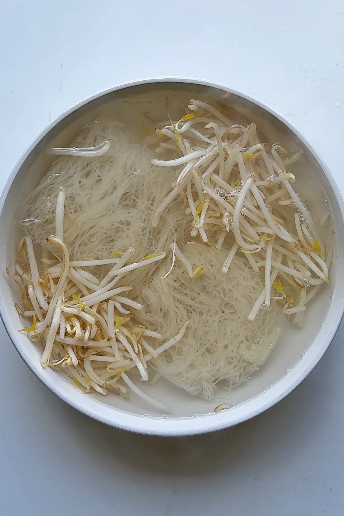 cooking vermicelli noodles and beansprouts.