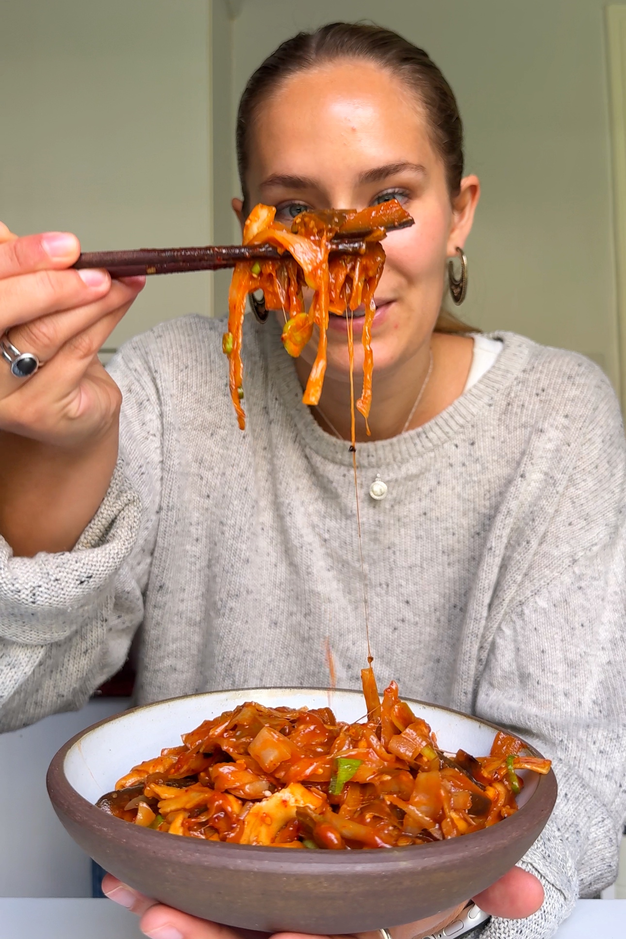 Emily Roz holding up the one pot spicy gochujang lasagne.