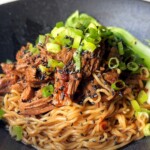 black ramen bowl with beef and ramen noodles.