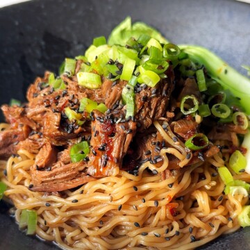 black ramen bowl with beef and ramen noodles.