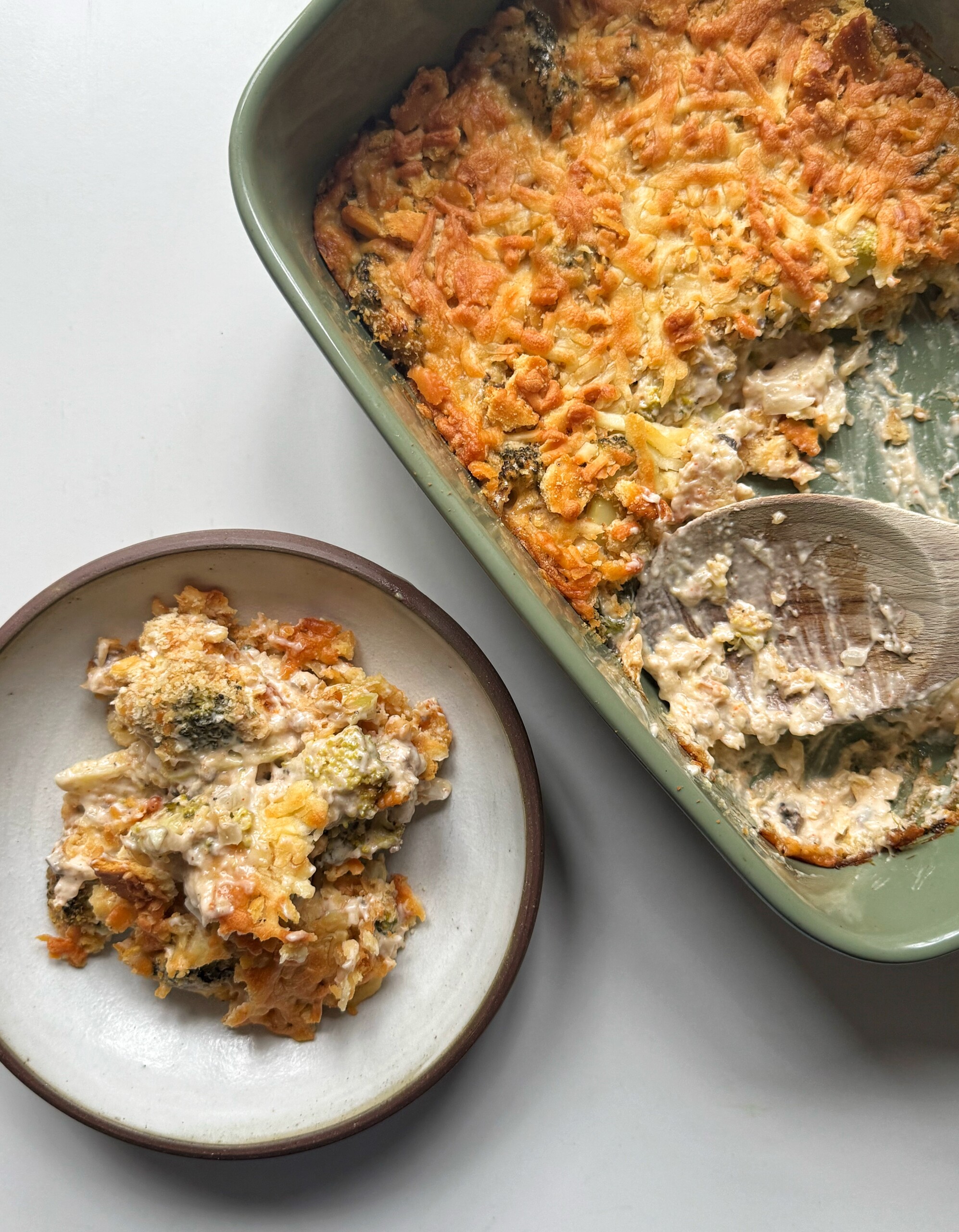 dish of broccoli casserole with a bowl of broccoli casserole.