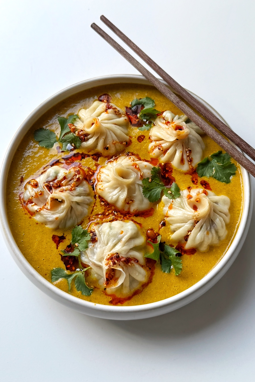 a bowl of jhol momo nepalese dumplings.