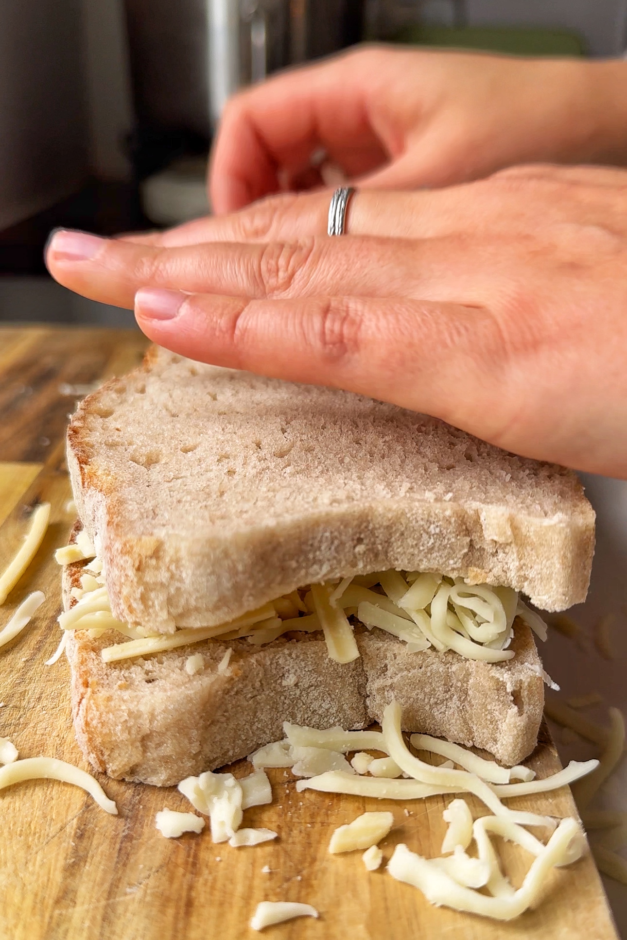assembling the tuna melt cheese in-between two pieces of bread.