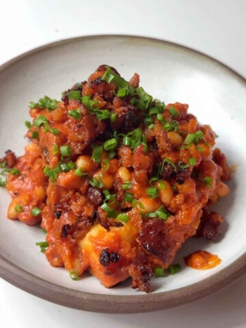 jacket potato topped with cheesy beans, fried chorizo and chives.