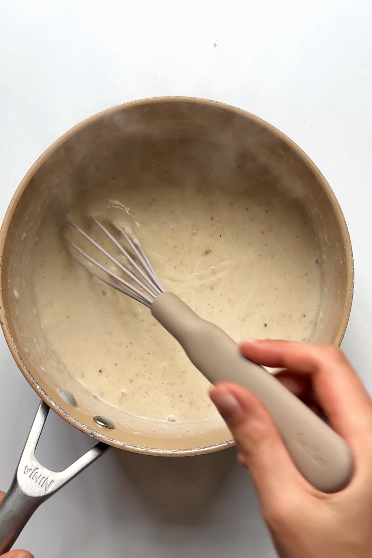 Making a bechamel sauce.