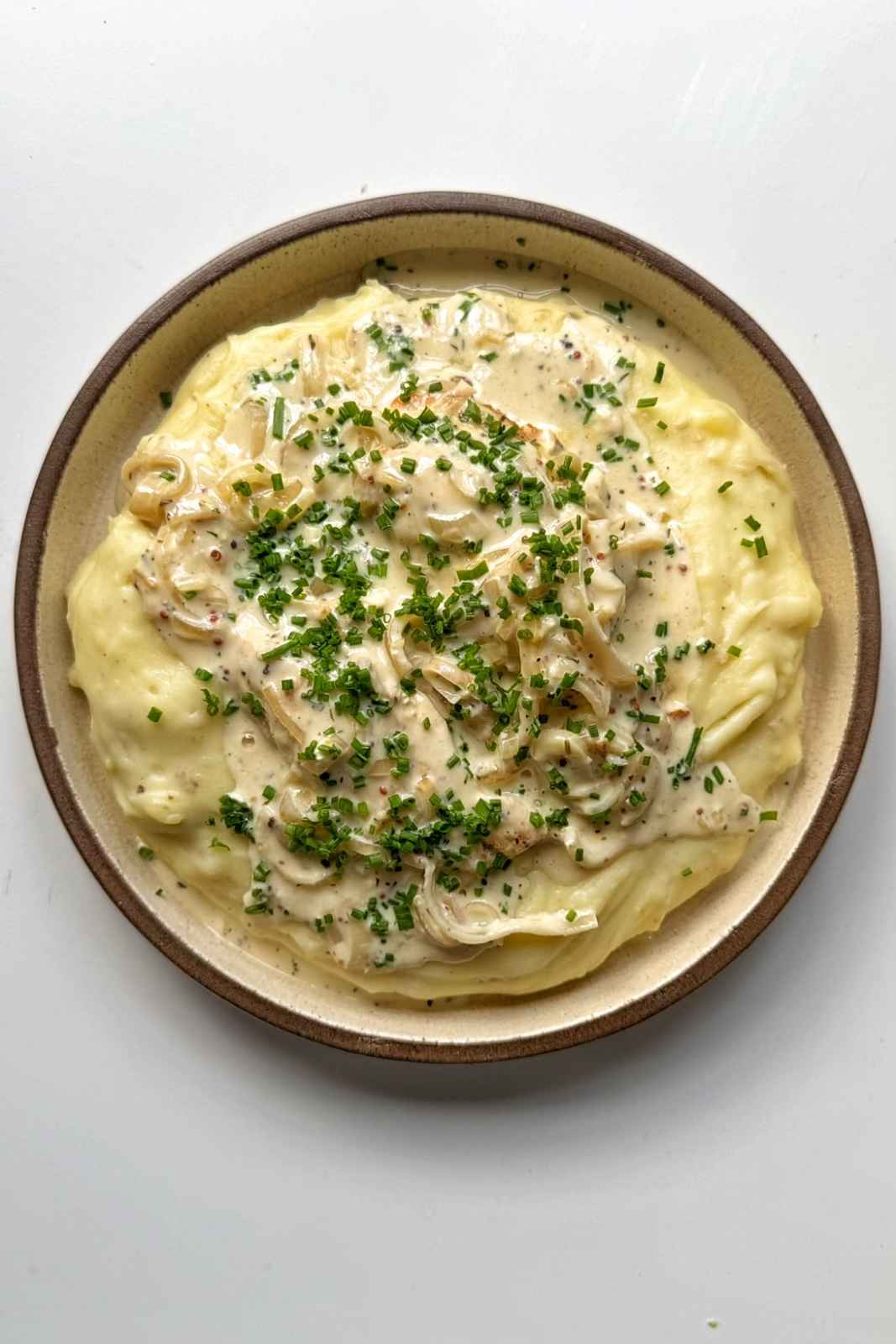 dijon mustard chicken on a bed of mashed potato.