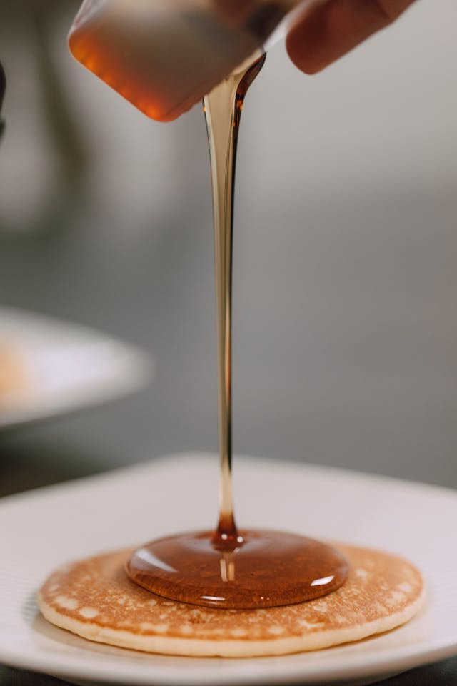 Agave syrup drizzled onto pancakes as a maple syrup alternative.