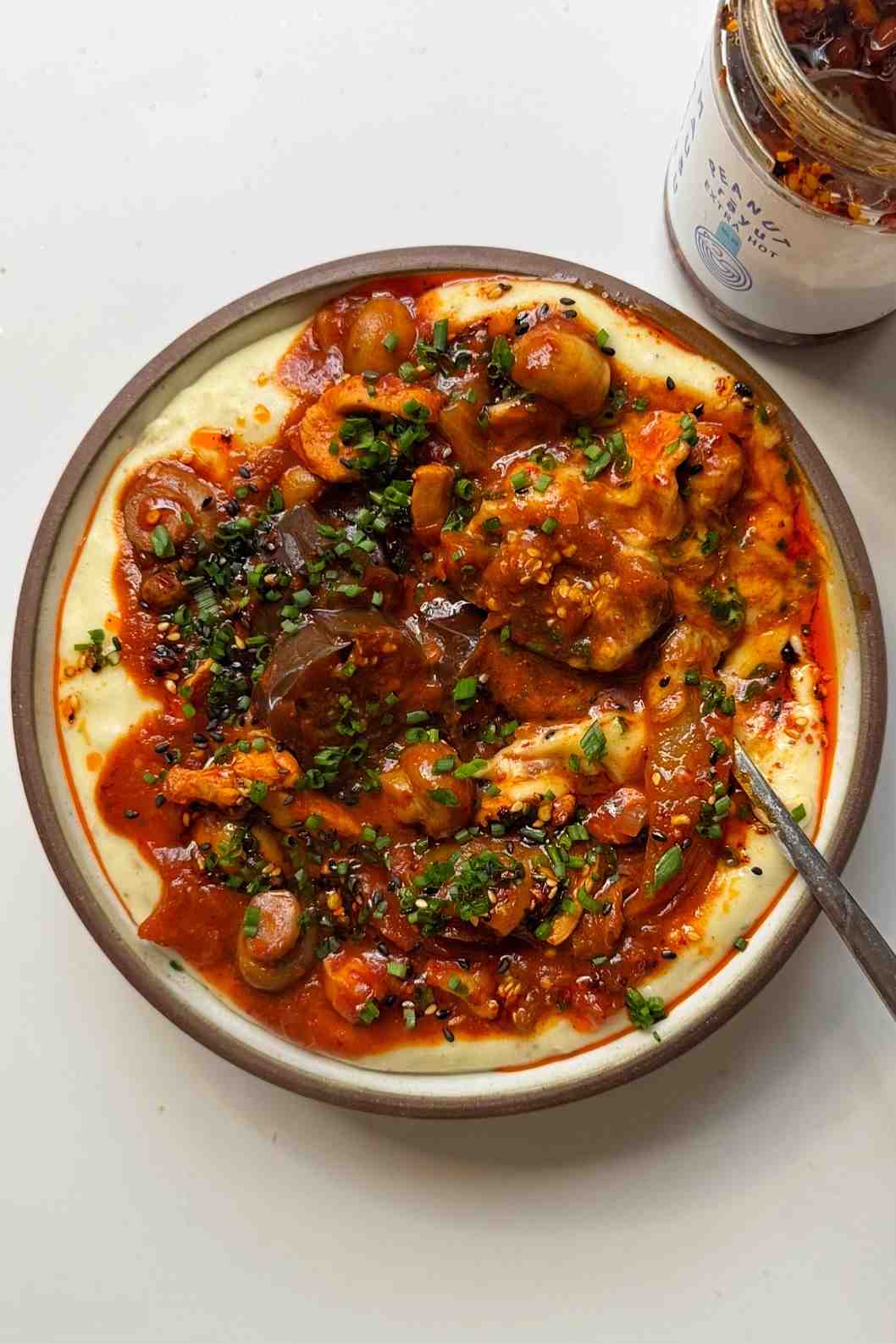 Korean-style stew with gochujang, eggplant, mushrooms, kimchi and silken tofu, served on mashed potato with chili oil drizzle.