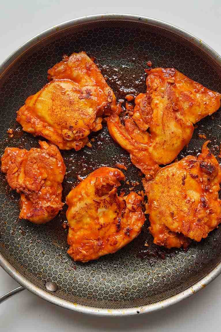 Frying fire chicken in a skillet.