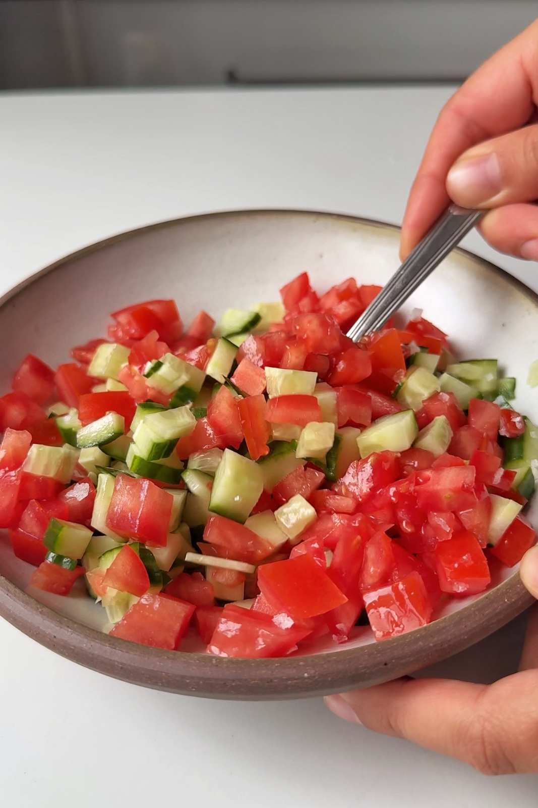 Fresh cucumber and tomatoes in a bowl.